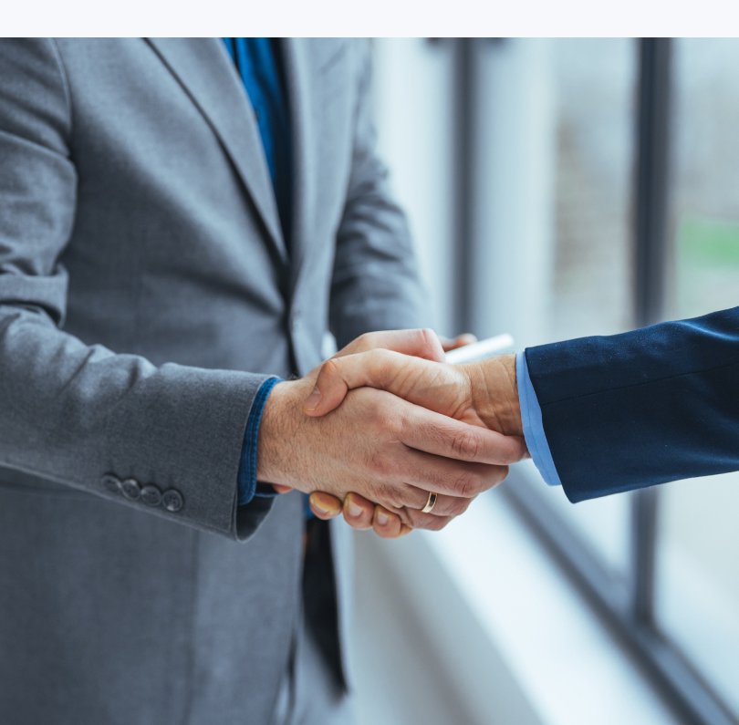 Two executives shaking hands after a strategic meeting
